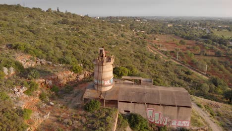 Derelict-quicklime-factory-building-in-Portugal,-panning-right,-high-angle