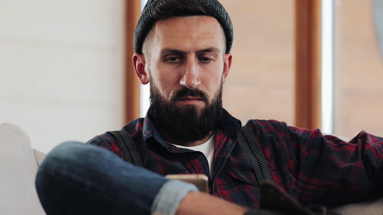 Man using a mobile phone indoors