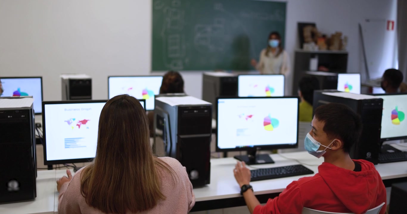 Students Using Computers in Classroom with Teacher