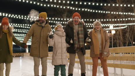 family ice skating at night