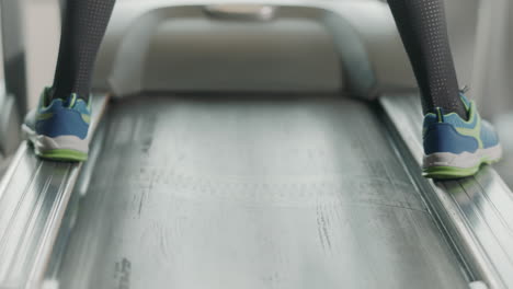 back view of fitness shoes jumping on treadmill boards.