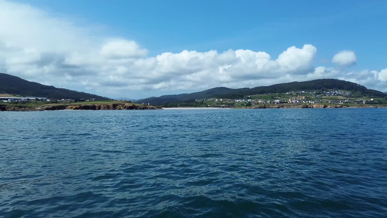Calm ocean view at Lugo beach, Galicia, under sunny blue sky