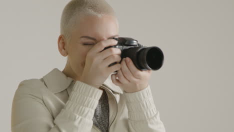 young woman using a digital camera against white background 02