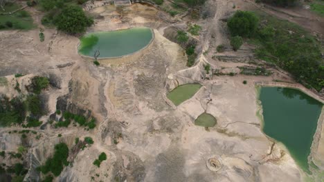 Aerial-of-Hierve-el-Agua,-which-translates-to-"the-water-boils,"-a-series-of-stunning-mineral-laden-rock-formations-that-resemble-cascading-waterfalls,-Mexico