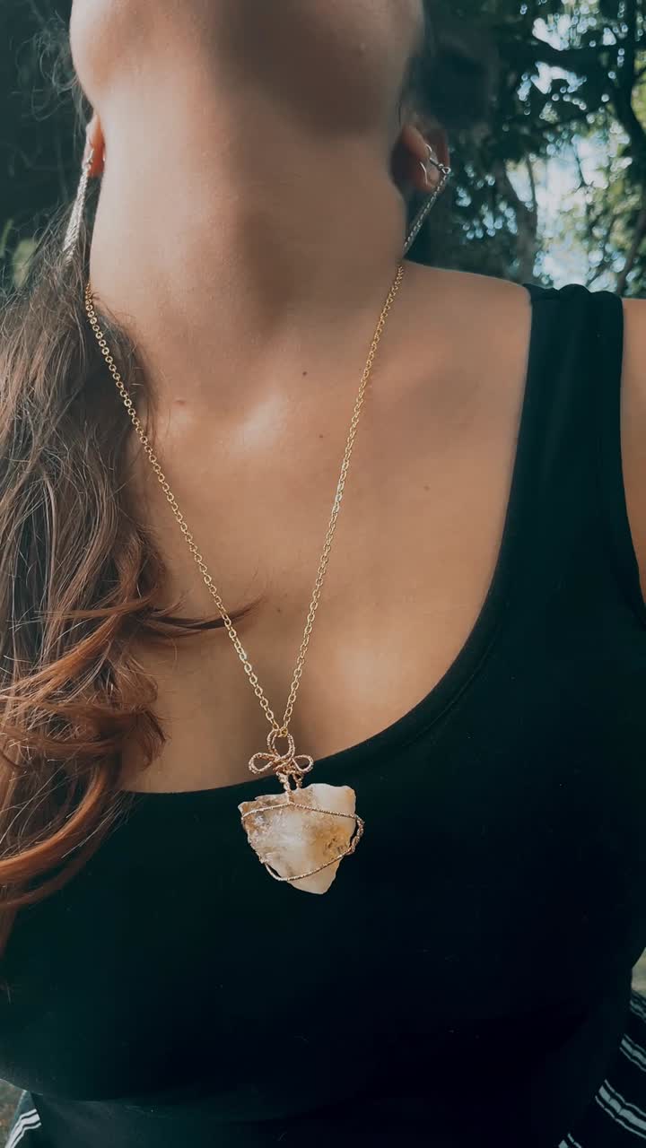 Woman wearing a beautiful wire-wrapped quartz necklace