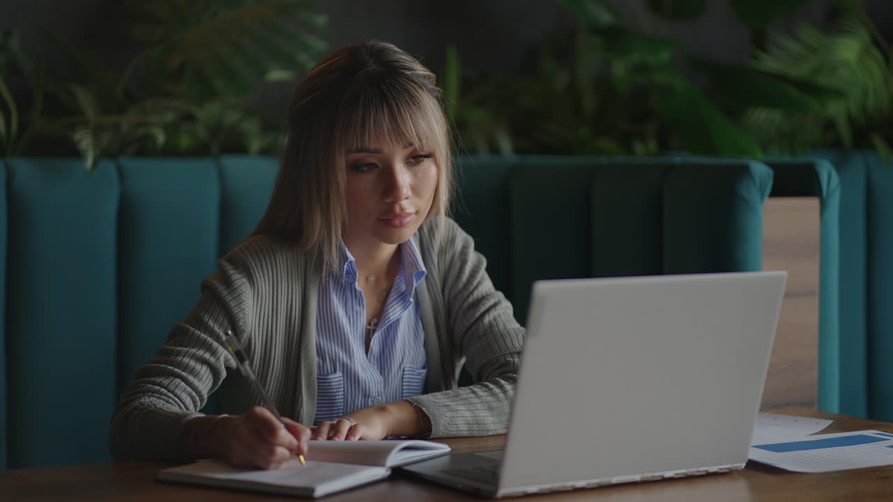 Happiness Attractive Asian woman working with computer laptop thinking to get ideas and requirement in Business startup at modern office or Co-working spaceBusiness Startup Concept
