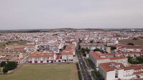 dense spanish town with whitewashed houses, aerial orbit