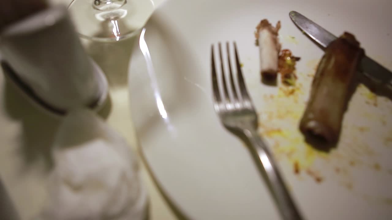 Dirty Dish On Food Table. Wasted food on served festive table after dinner party