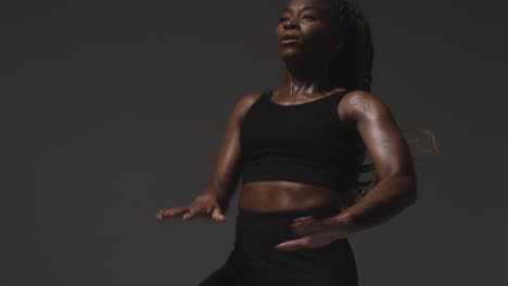 Studio-Shot-Of-Woman-Wearing-Gym-Fitness-Clothing-Exercising-Running-On-The-Spot-5