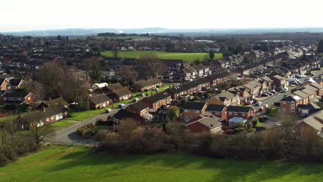 rural british townhouse neighbourhood homes with green space aerial view across to snowdonia mountain skyline, panning right