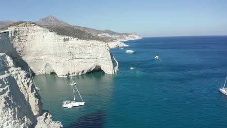 Aerial-View-of-Tropical-Island-with-White-Rocks-and-Boats-in-Bay