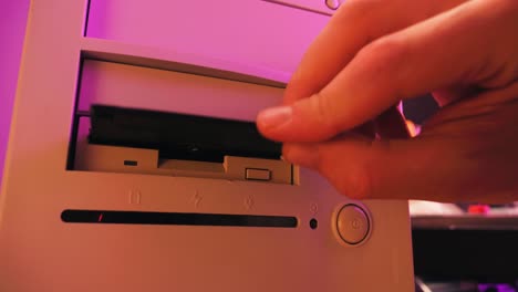 inserting/removing a floppy disk into a vintage computer