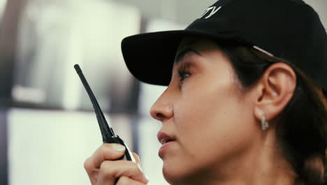 woman security guard talking on a radio