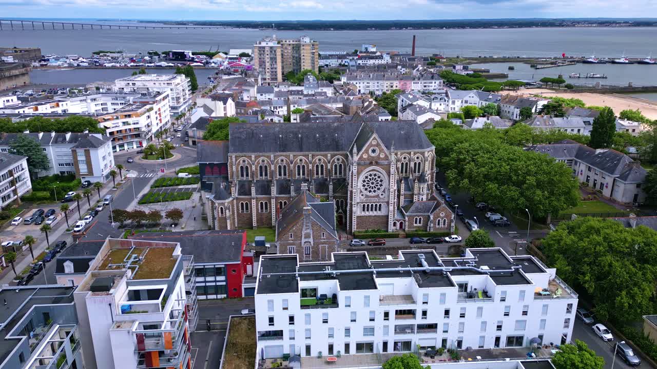 Aerial View of a European Coastal City with a Grand Cathedral, Port, and Bridge