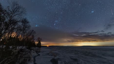 holy grail star scape timelapse at a frozen lake, transition from night to sunrise