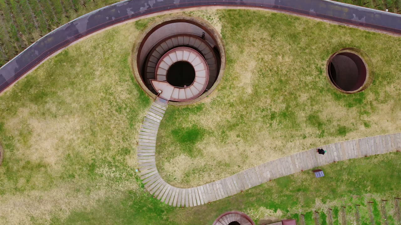 Top Down drone spinning aerial view above a spiral staircase of Italian Winery in Tuscany