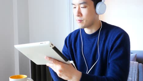 man using digital tablet while having breakfast 4k