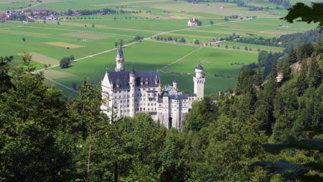 Neuschwanstein-Castle-in-Schwangau,-Germany,-centered,-overlooking-Alps-valley