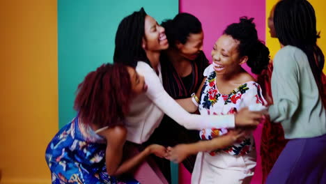 group of diverse women laughing and embracing together
