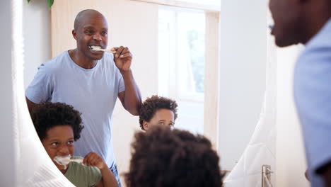 Man,-children-or-brushing-teeth-in-mirror