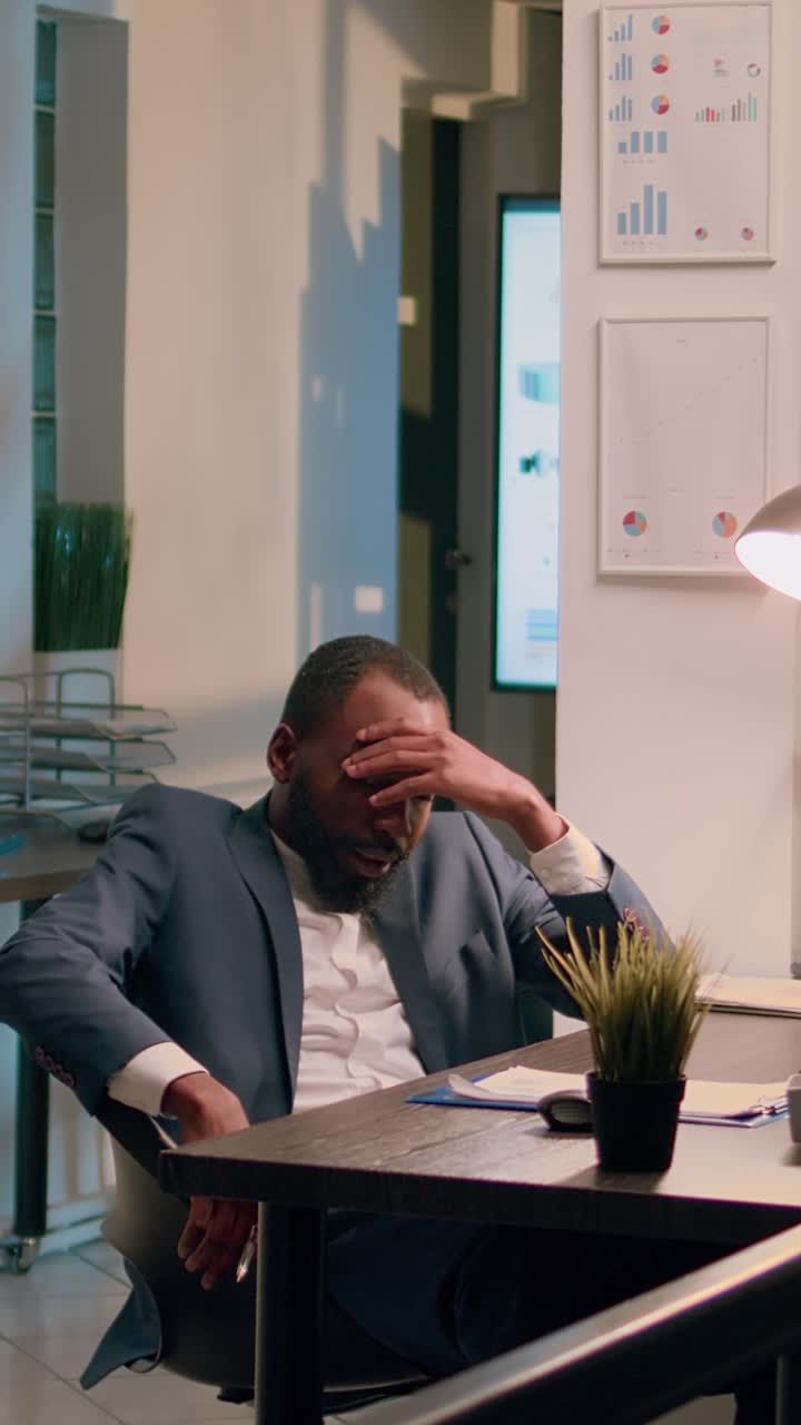 Vertical video Drowsy accountant sleeping in office