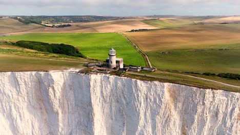 the belle tout lighthouse situated on the edge of the beautiful seven sisters chalk cliffs and stunning green fields