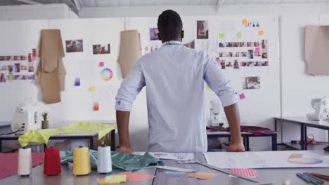 Mixed-race-man-working-in-fashion-office