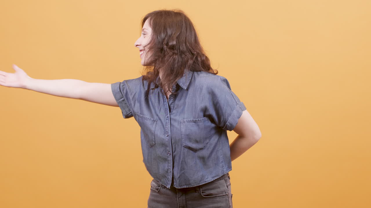 A smiling woman in a denim shirt