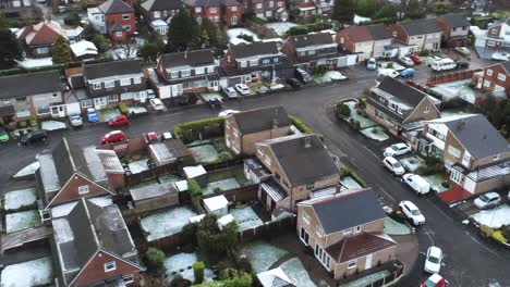 snowy aerial village residential neighbourhood winter frozen north west slow birdseye right over houses and roads