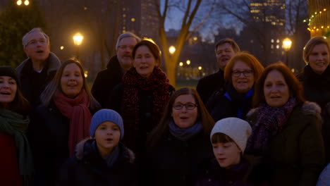 group of people singing outdoors in winter