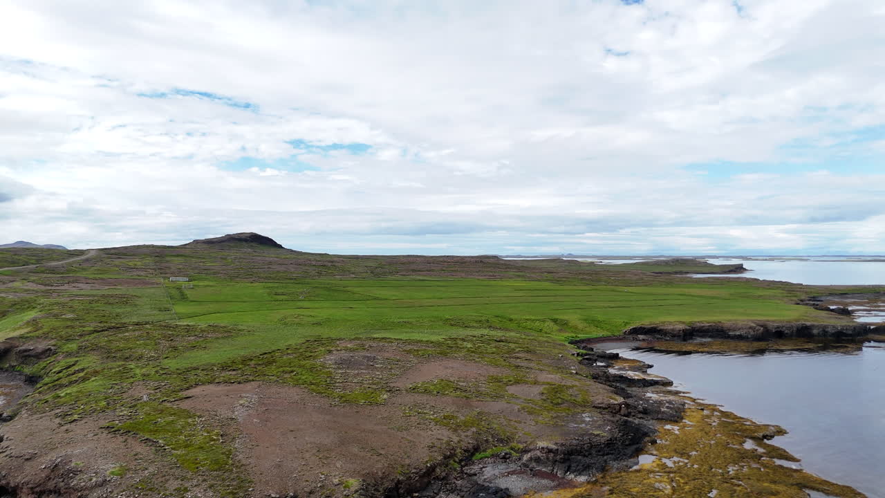 Aerial view of Hvammsfjörður archipelago along Road 54 in Vesturland Iceland, showing scattered islands, winding coastline, and open water under natural light
