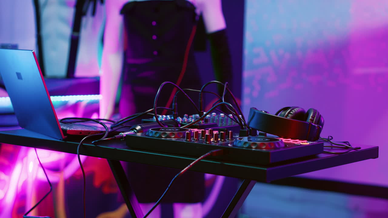DJ Setup with Mixing Console, Headphones, and Laptop