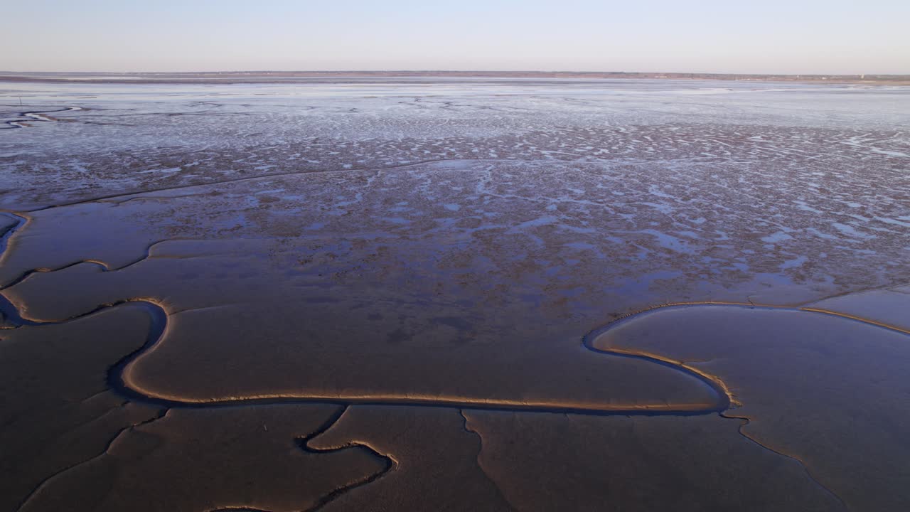 Endless wetlands and river with deep branches cascades through, aerial drone fly forward shot