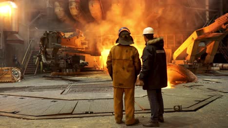 steel mill workers observing hot metal