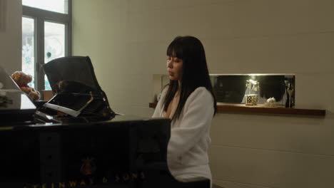 pretty asian girl practicing piano at home