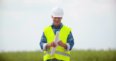 Engineer-Reading-Blueprint-And-Working-On-Alternative-Energy-Windmill-Farm-