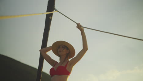 woman in red bikini at sunset beach