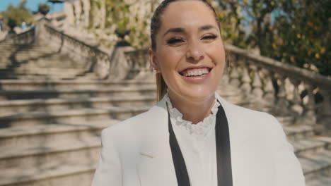 stylish young woman laughing outdoors.