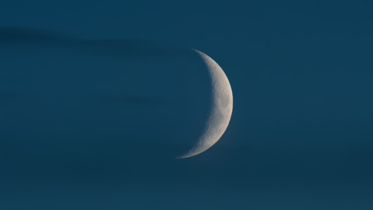 Close up of crescent moon illuminated against a deep blue sky