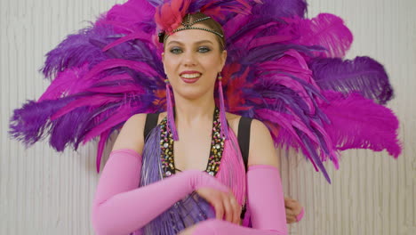 two dancers in feather outfit dancing and showing their moves