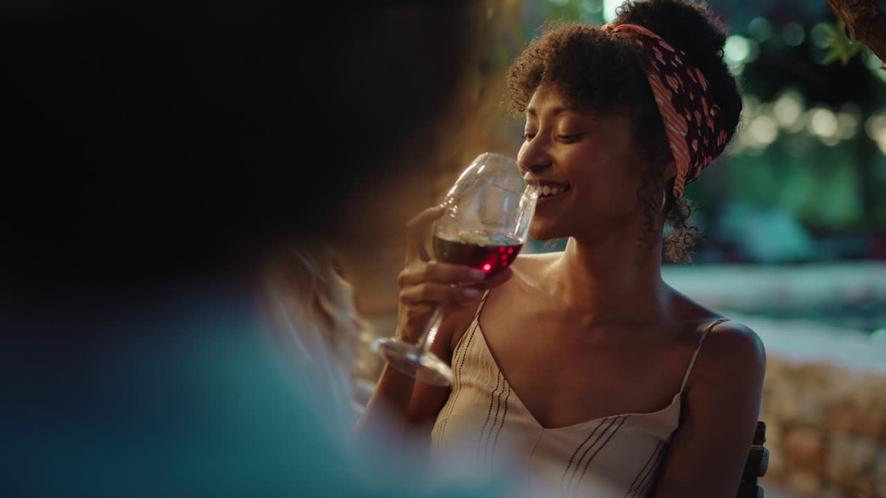 beautiful african american woman enjoying dinner date flirting with man couple drinking wine making toast celebrating romantic evening together 4k