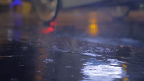 drizzle and puddles on the asphalt with lights reflection