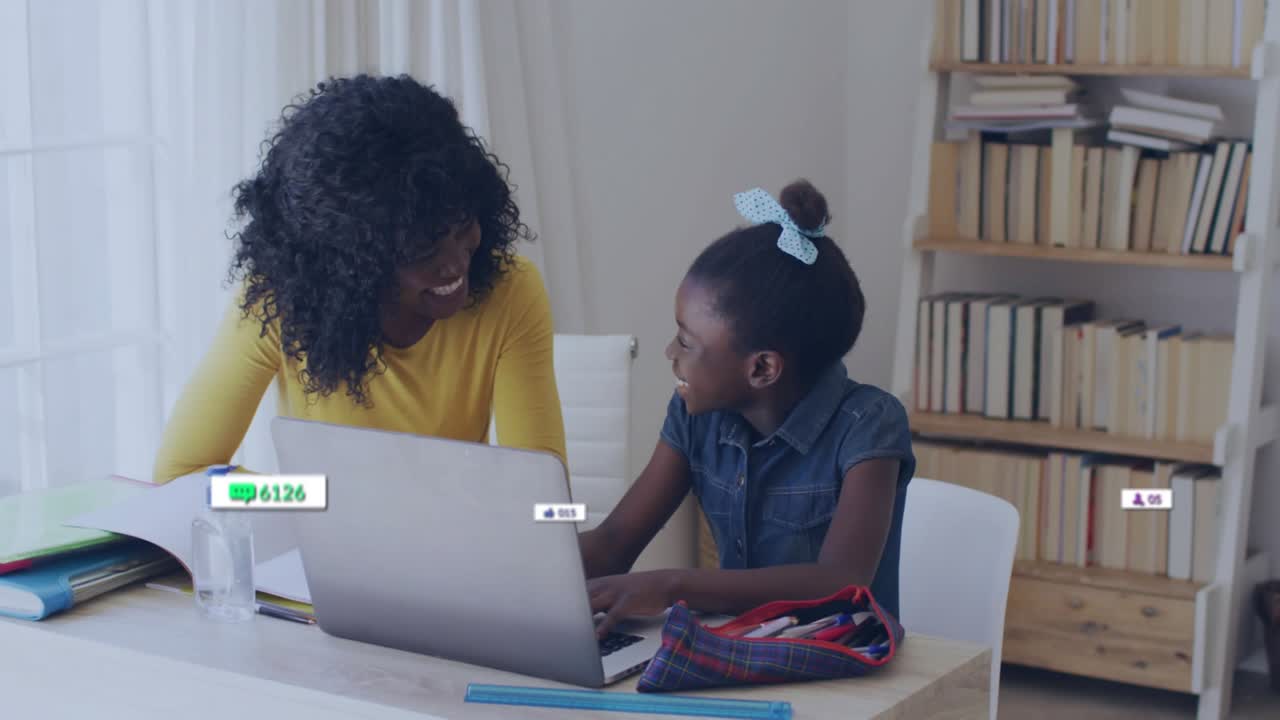 Mother and child with laptop while typing being guided and growing floating social engagement icons