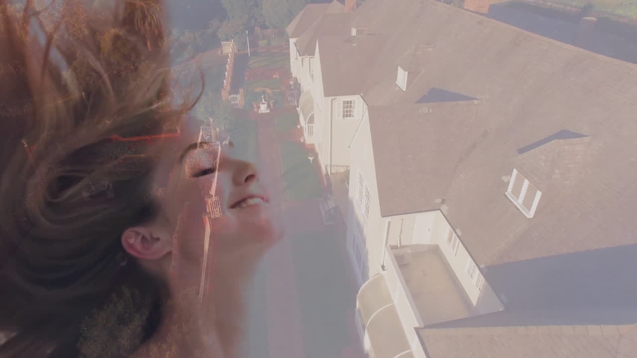 Flipping hair joyfully, woman enjoying animation over suburban neighborhood view