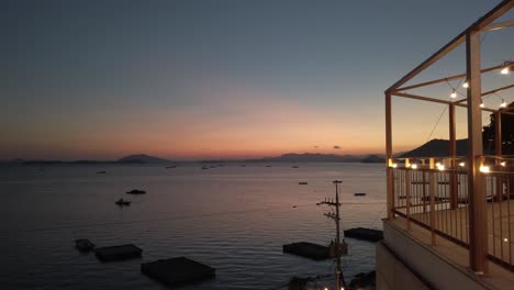 Push-in-past-balcony-overlooking-Suncheon-Bay-at-sunset