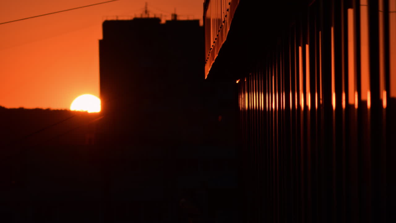 Sunset view over the city skyline reflecting vibrant colors during evening hours