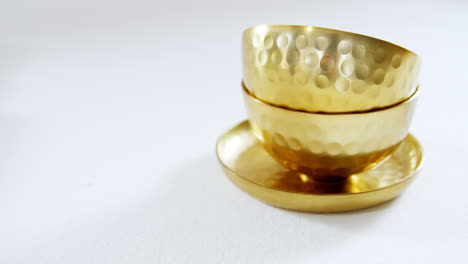 golden steel bowls and plate on white background 4k