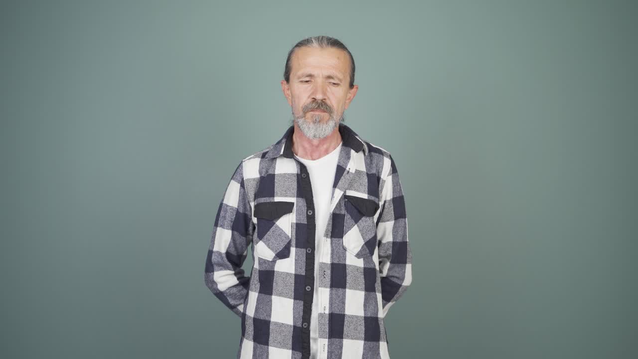Man looking at camera with dull expression.
