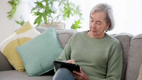 Credit-card,-tablet-and-senior-woman-on-sofa