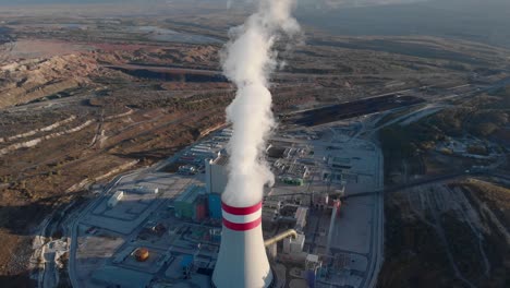 drone coal fired power station plant cooling towers emitting steam tilt up